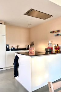 keukeninspiratie witte strakke keuken met warme zalmkleurige muren